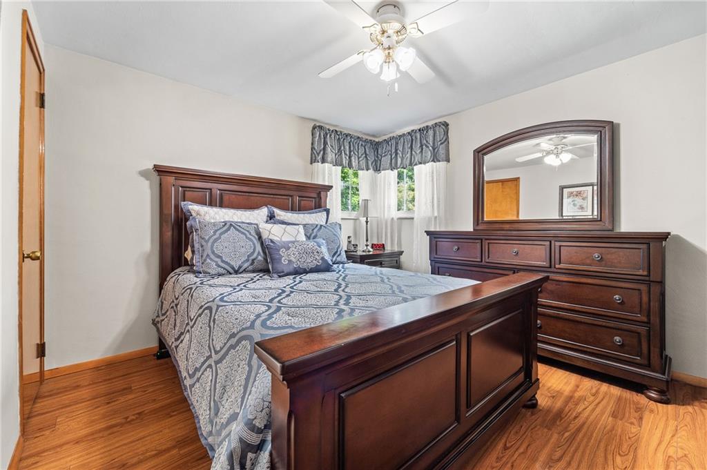 239 Roberts Road Pittsburgh, PA 15239 - Photo 13 of 30 a bedroom with a bed and a chandelier