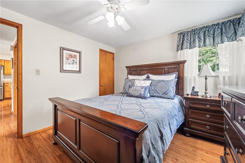 239 Roberts Road Pittsburgh, PA 15239 - Photo 14 of 30 a bedroom with a bed and a chandelier