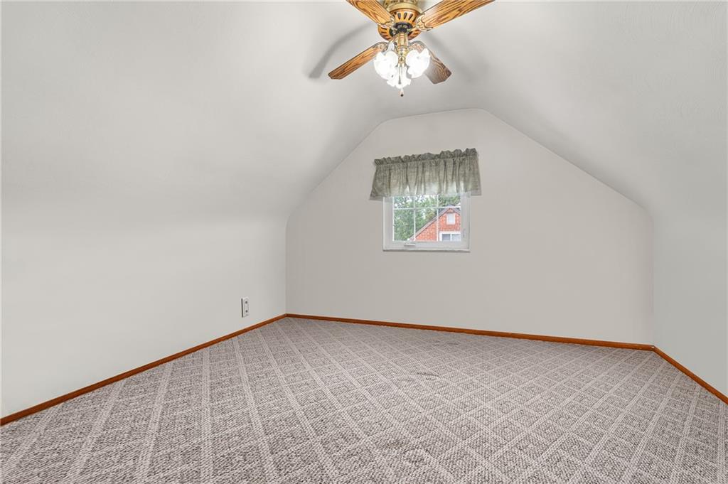 239 Roberts Road Pittsburgh, PA 15239 - Photo 16 of 30 an empty room with a chandelier fan and wooden floor