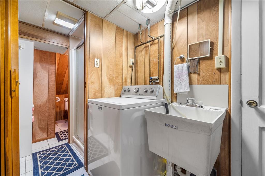 239 Roberts Road Pittsburgh, PA 15239 - Photo 21 of 30 a bathroom with a sink a mirror and a shower