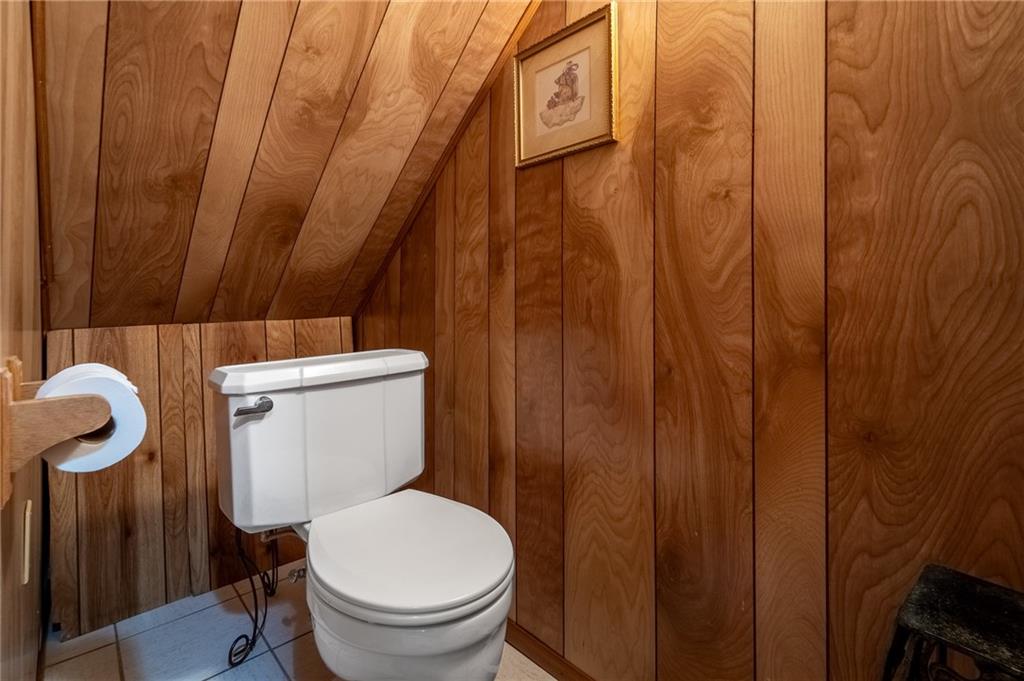 239 Roberts Road Pittsburgh, PA 15239 - Photo 23 of 30 a white toilet sitting next to a shower curtain