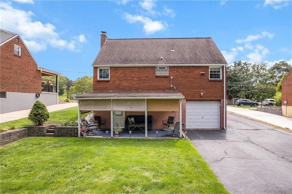 239 Roberts Road Pittsburgh, PA 15239 - Photo 26 of 30 a front view of a house with a garden and outdoor seating