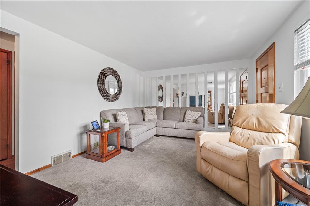 239 Roberts Road Pittsburgh, PA 15239 - Photo 6 of 30 a living room with furniture and a clock