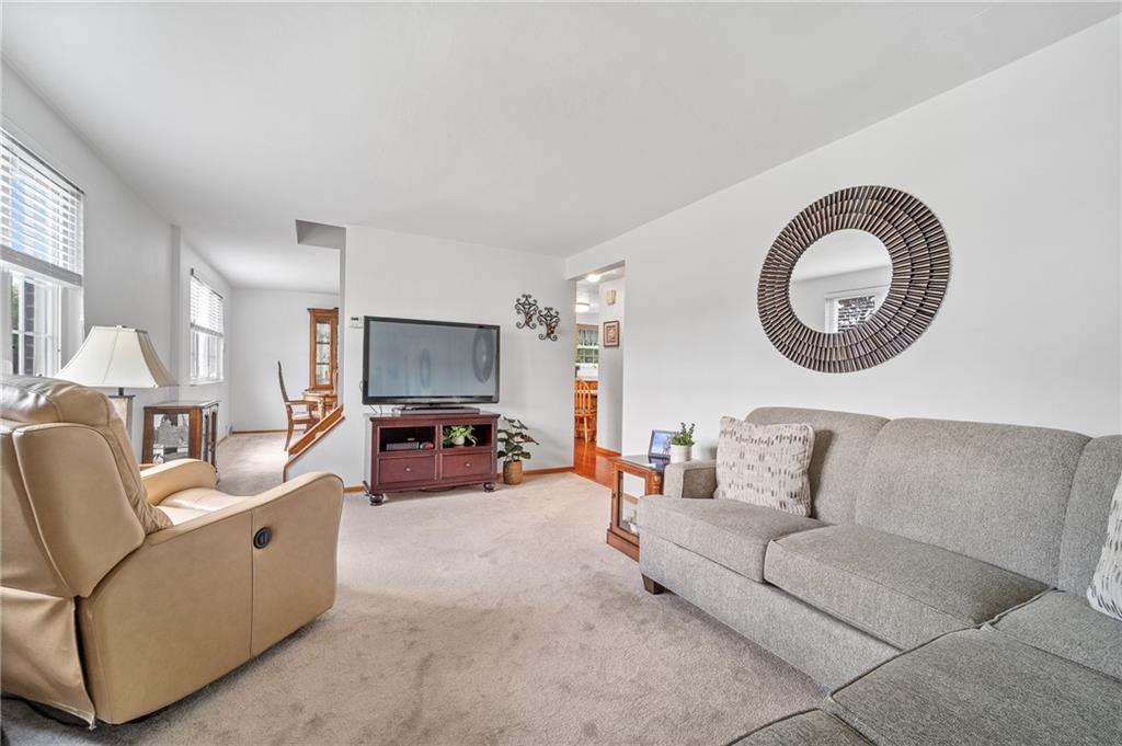 239 Roberts Road Pittsburgh, PA 15239 - Photo 7 of 30 a living room with furniture and a fireplace