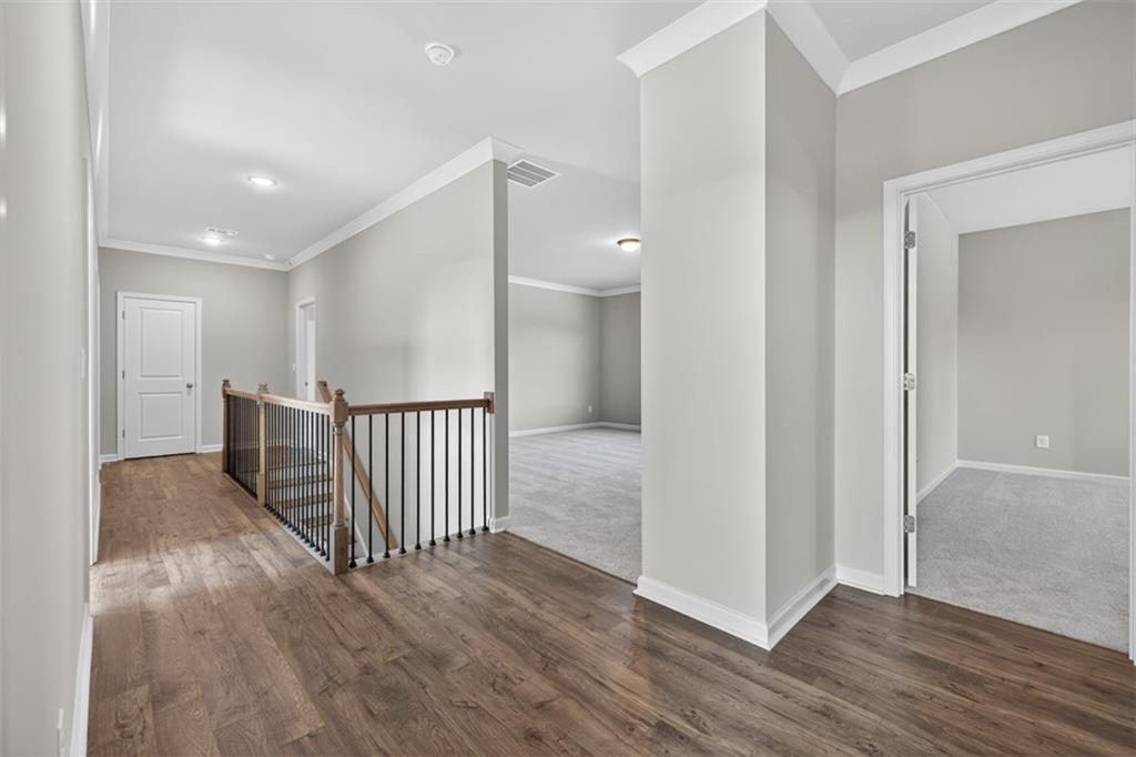8845 Jot Em Down Road Gainesville, GA 30506 - Photo 36 of 87 a view of a hallway with wooden floor
