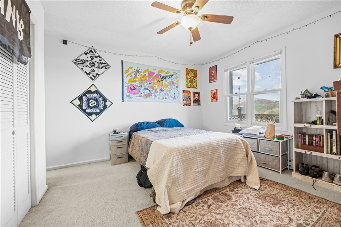 200 Pilgrims Way, Unit 12 Boone, NC 28607 - Photo 12 of 21 a bedroom with a bed and a chandelier