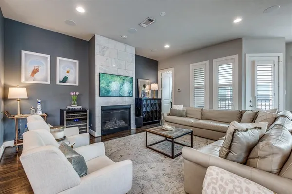 a living room with fireplace furniture and a flat screen tv