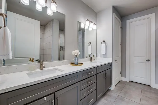 a bathroom with double sink and a mirror