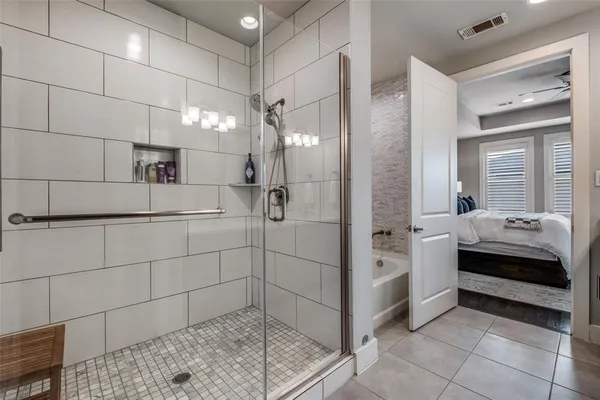 a bathroom with a bathtub and a shower