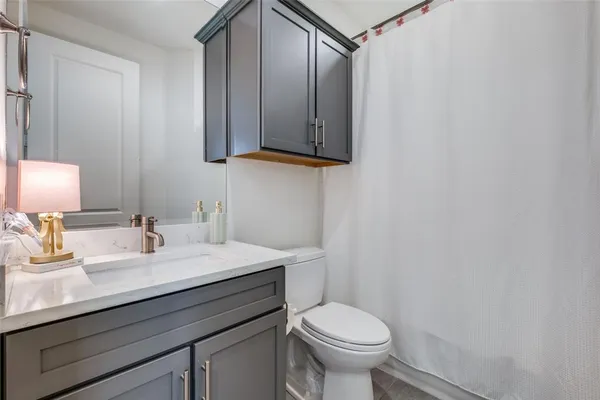 a bathroom with a sink toilet and mirror