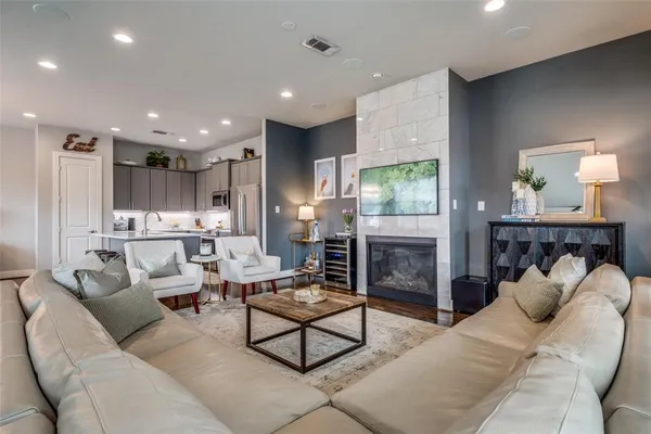 a living room with furniture a fireplace and a table