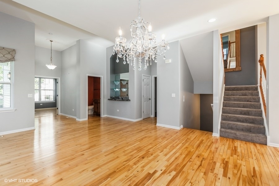 303 Quarry Ridge Circle Sugar Grove, IL 60554 - Photo 5 of 29 a view of a livingroom with wooden floor and stairs
