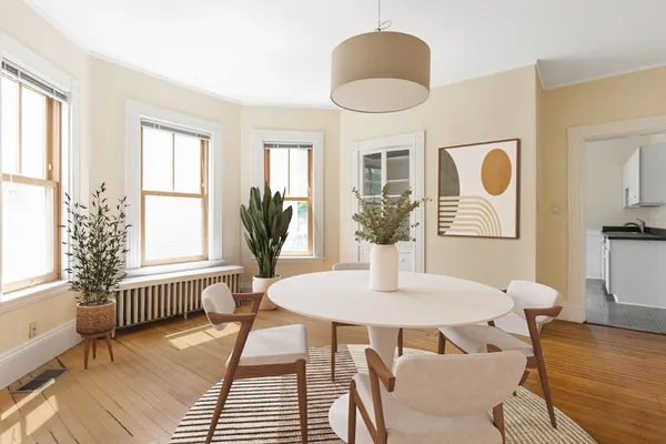a view of a dining room with furniture and wooden floor