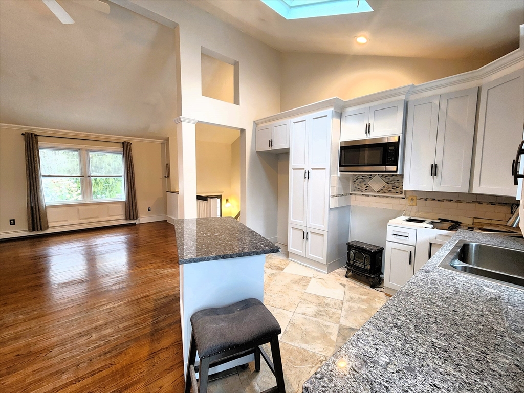 204 Lower Gore Road Webster, MA 01570 - Photo 5 of 36 a kitchen with granite countertop a stove a sink and a refrigerator