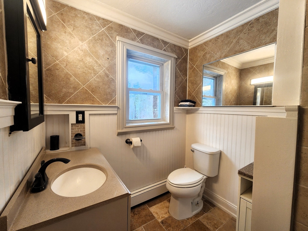 204 Lower Gore Road Webster, MA 01570 - Photo 8 of 36 a bathroom with a toilet a sink and mirror