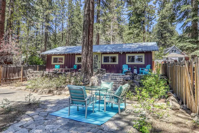 a view of a house with backyard and sitting area