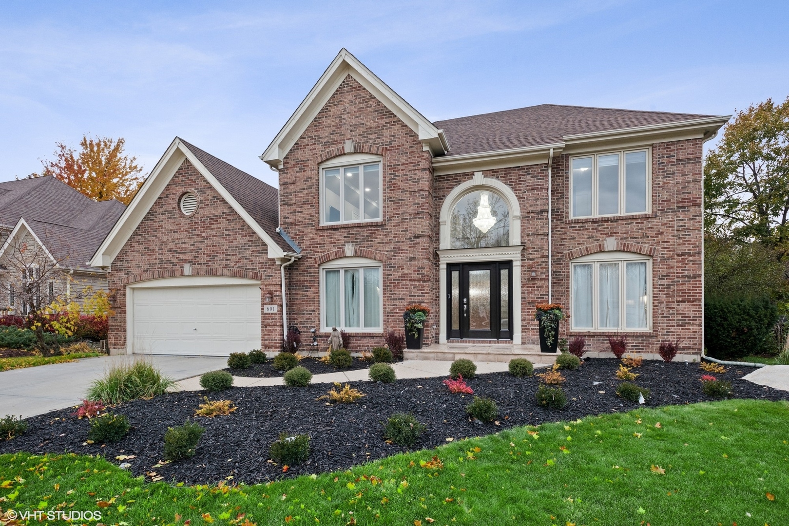 a front view of a house with a garden and plants