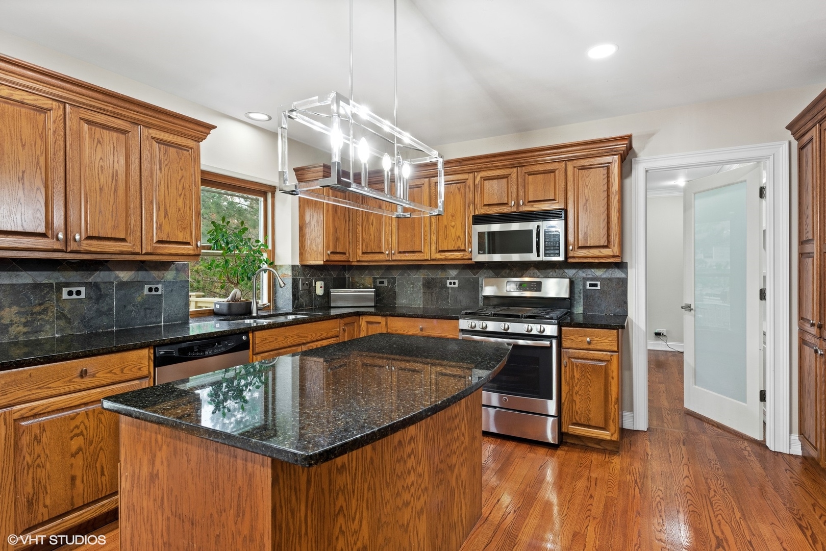 601 Partridge Drive West Chicago, IL 60185 - Photo 13 of 39 a kitchen with stainless steel appliances a stove a sink and a microwave