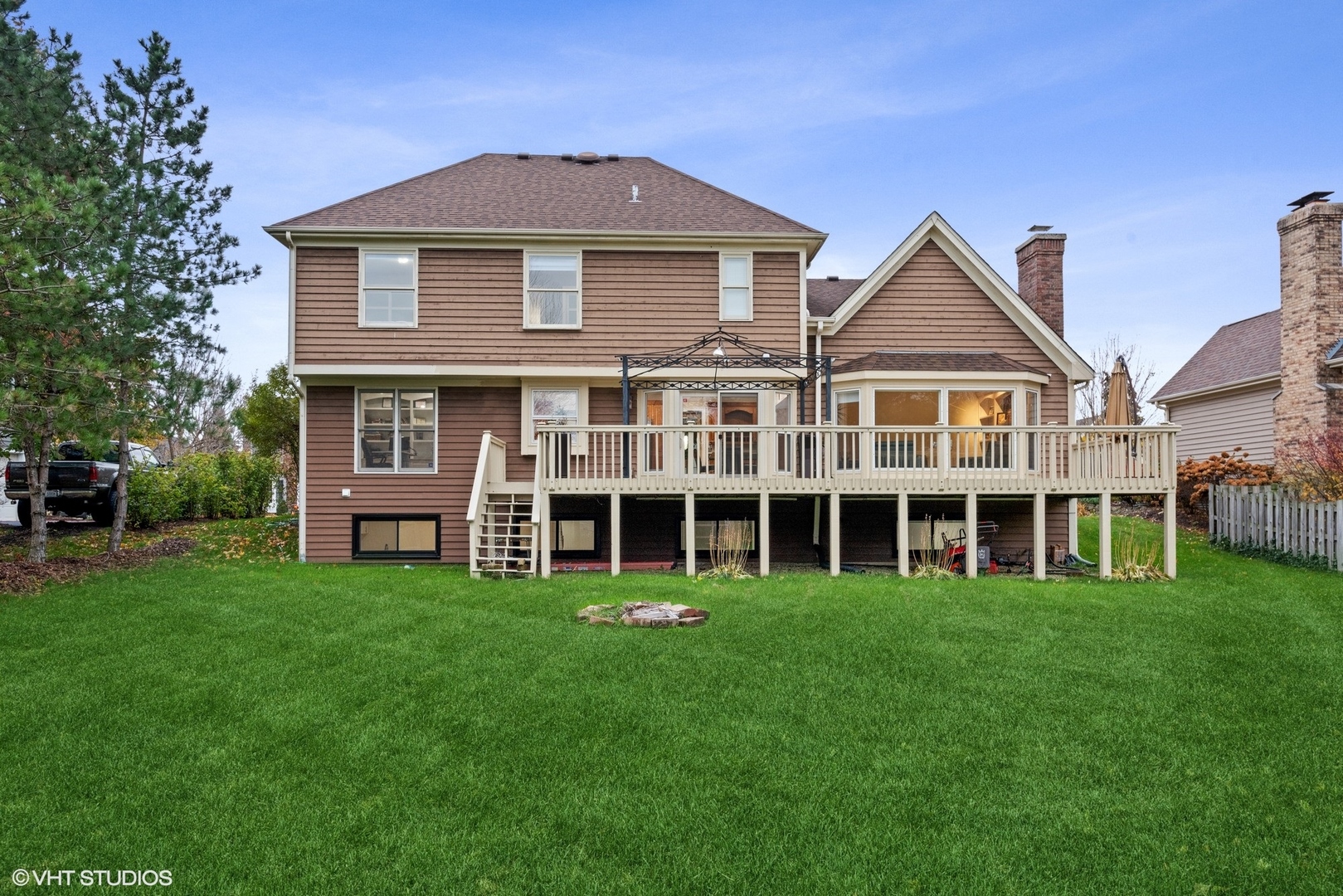 601 Partridge Drive West Chicago, IL 60185 - Photo 2 of 39 a view of a large residential apartment with a big yard and large trees