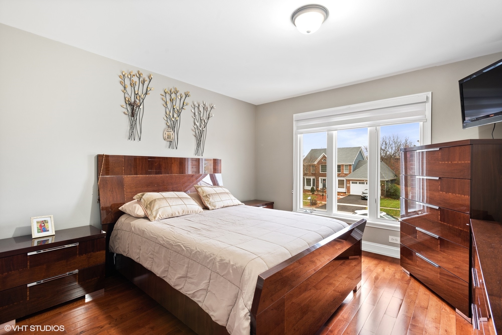 601 Partridge Drive West Chicago, IL 60185 - Photo 21 of 39 a bedroom with a bed flat screen tv and a large window