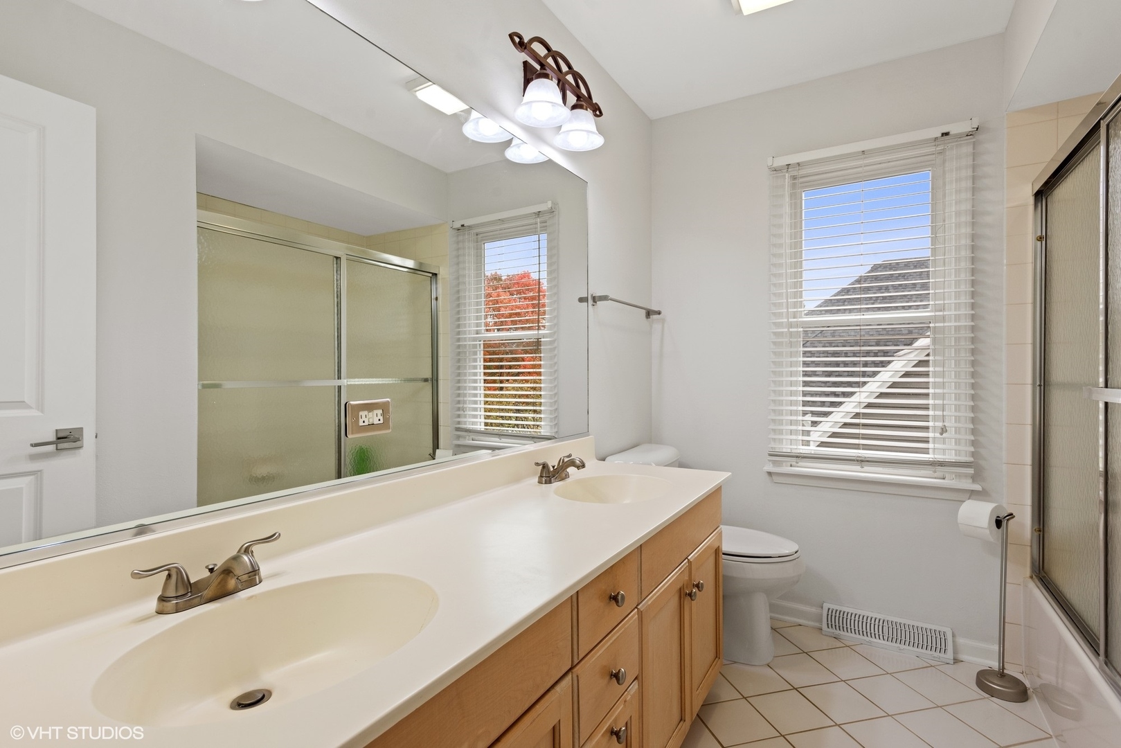 601 Partridge Drive West Chicago, IL 60185 - Photo 22 of 39 a bathroom with a sink a toilet a mirror and shower