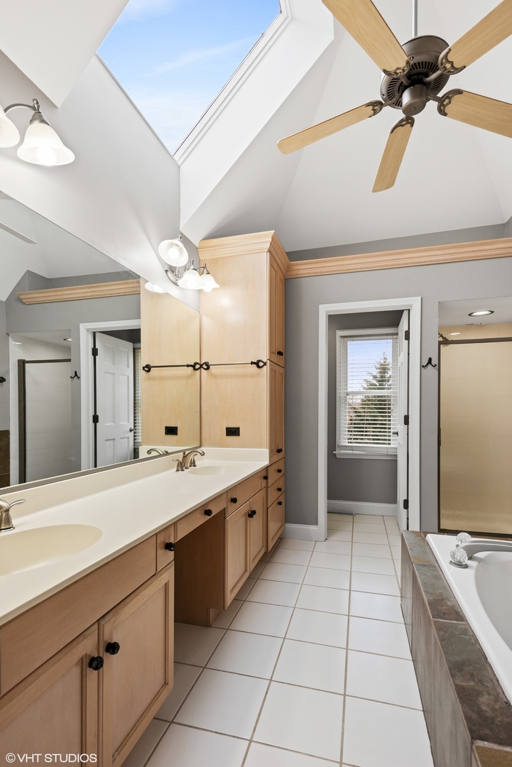 601 Partridge Drive West Chicago, IL 60185 - Photo 26 of 39 a large bathroom with a granite countertop sink mirror and bathtub