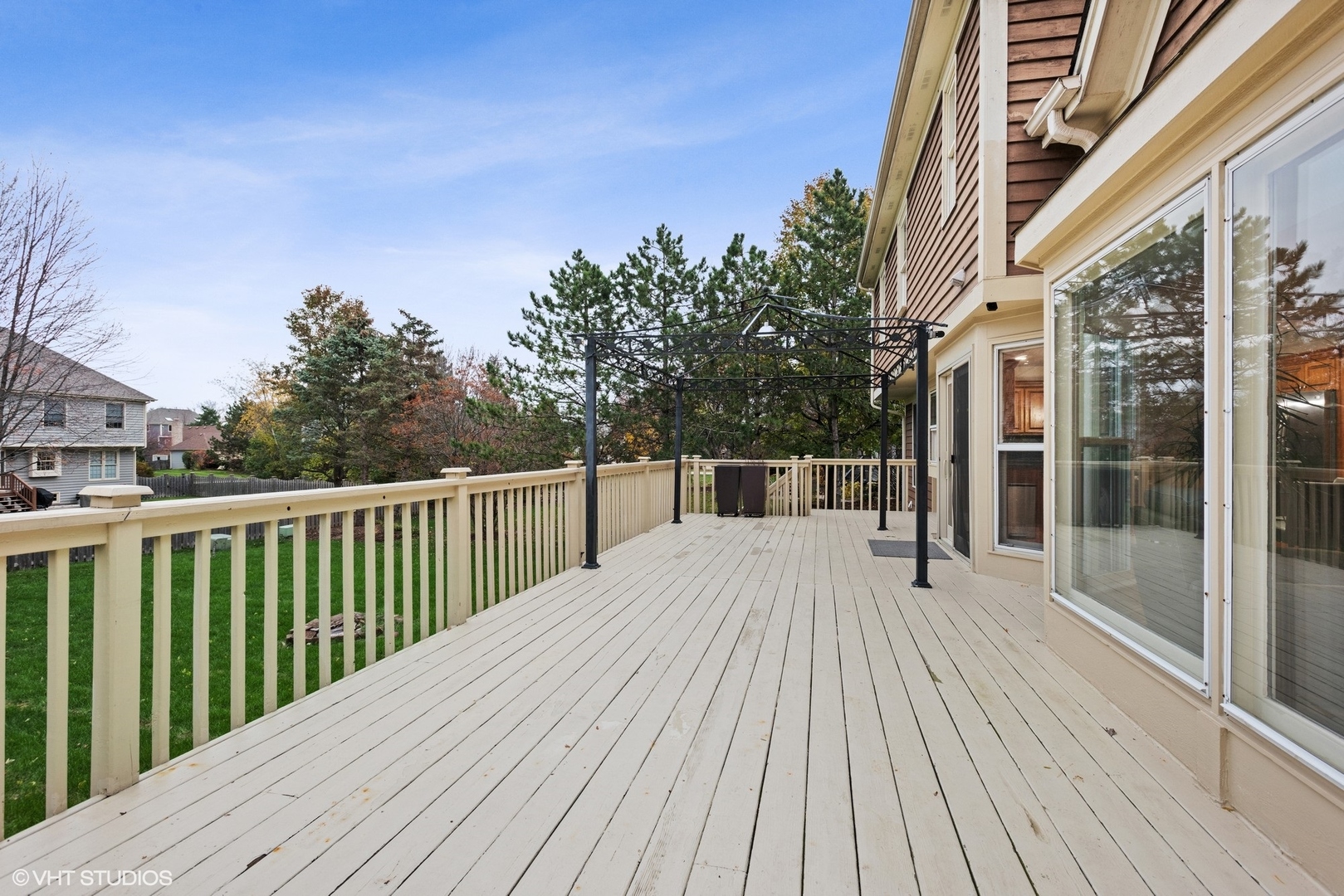 601 Partridge Drive West Chicago, IL 60185 - Photo 3 of 39 a balcony with wooden floor and fence