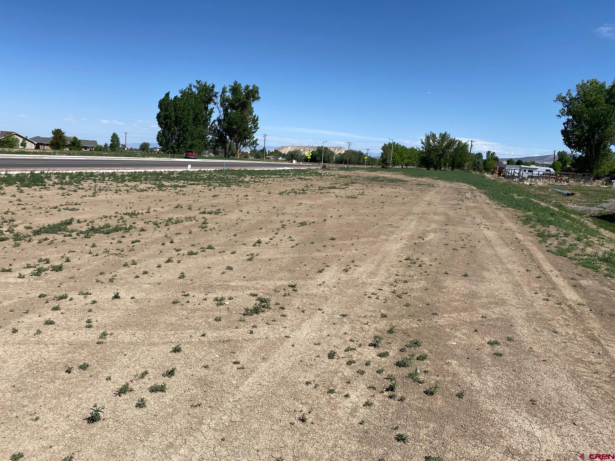 Lot 8 6700th Road Montrose, CO 81401 - Photo 8 of 8 a view of a lake with a house in the background