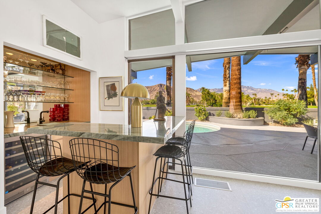40181 Sand Dune Road Rancho Mirage, CA 92270 - Photo 22 of 75 a view of a dining room with furniture a chandelier and a rug