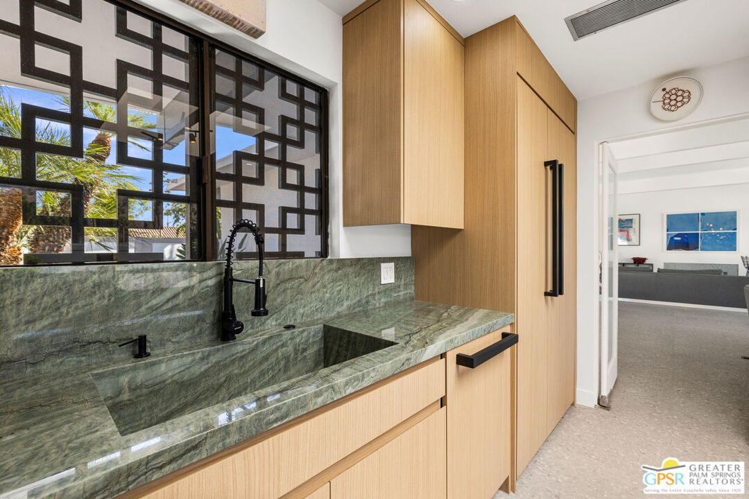 40181 Sand Dune Road Rancho Mirage, CA 92270 - Photo 29 of 75 a kitchen with granite countertop a sink and a stove
