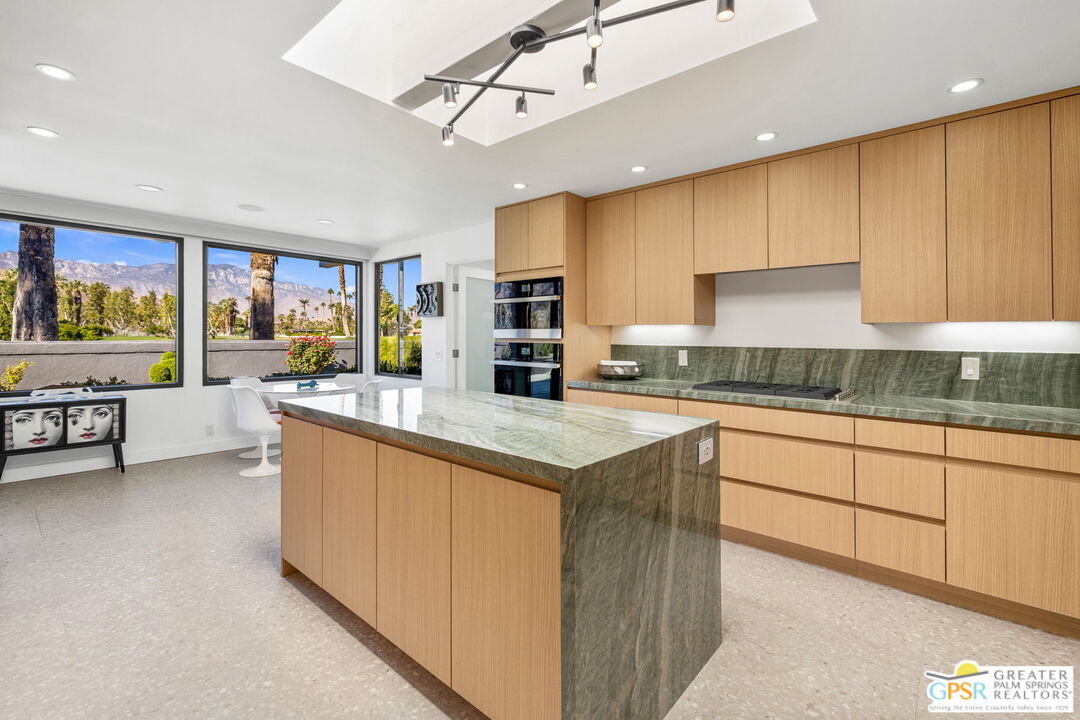 40181 Sand Dune Road Rancho Mirage, CA 92270 - Photo 30 of 75 a kitchen with stainless steel appliances granite countertop a stove and a sink