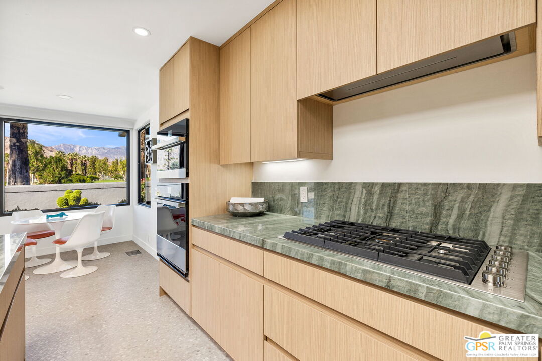 40181 Sand Dune Road Rancho Mirage, CA 92270 - Photo 32 of 75 a kitchen with a stove a sink and a refrigerator