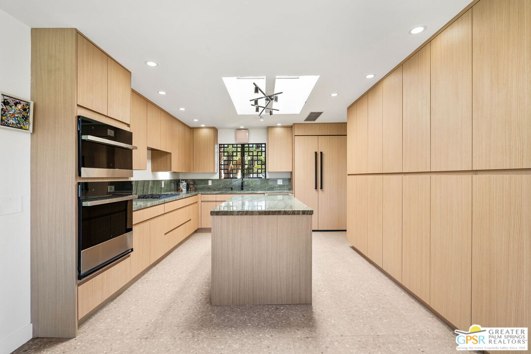 40181 Sand Dune Road Rancho Mirage, CA 92270 - Photo 34 of 75 a kitchen with stainless steel appliances a refrigerator and a stove top oven