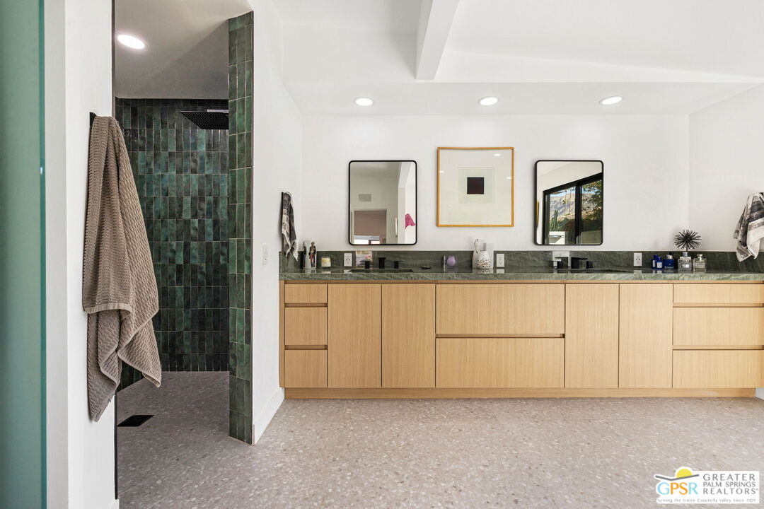 40181 Sand Dune Road Rancho Mirage, CA 92270 - Photo 50 of 75 a bathroom with a granite countertop sink and a mirror