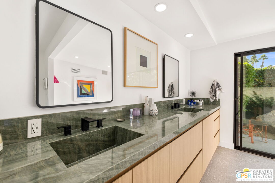 40181 Sand Dune Road Rancho Mirage, CA 92270 - Photo 52 of 75 a kitchen with stainless steel appliances granite countertop a sink and a wooden cabinets