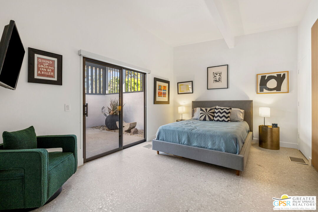 40181 Sand Dune Road Rancho Mirage, CA 92270 - Photo 59 of 75 a spacious bedroom with a bed and a couch
