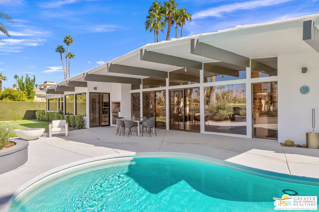 40181 Sand Dune Road Rancho Mirage, CA 92270 - Photo 64 of 75 a view of a patio with a table and chairs under an umbrella