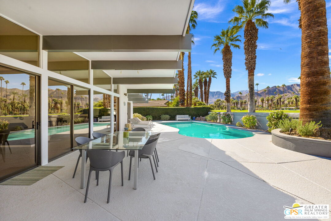 40181 Sand Dune Road Rancho Mirage, CA 92270 - Photo 65 of 75 a view of a patio with a table and chairs and potted plants