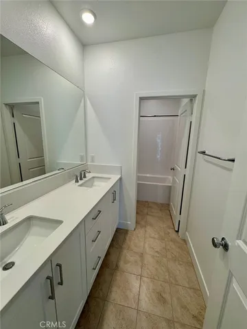 a bathroom with a double vanity sink and mirror