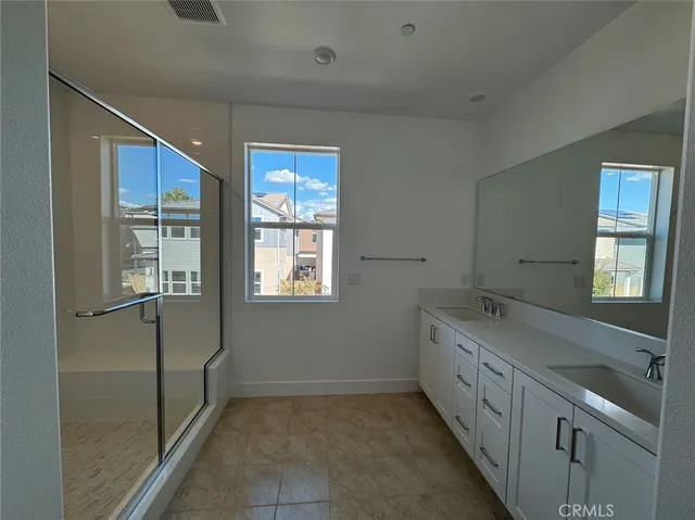 a bathroom with a granite countertop sink mirror and double