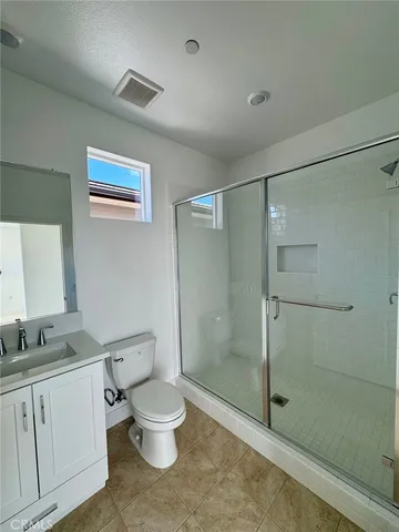 a white toilet sitting next to a bathroom sink