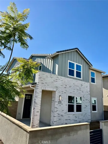 a front view of a house with plants