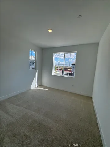 an empty room with a window and a fireplace