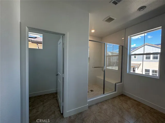 an empty room with windows and closet