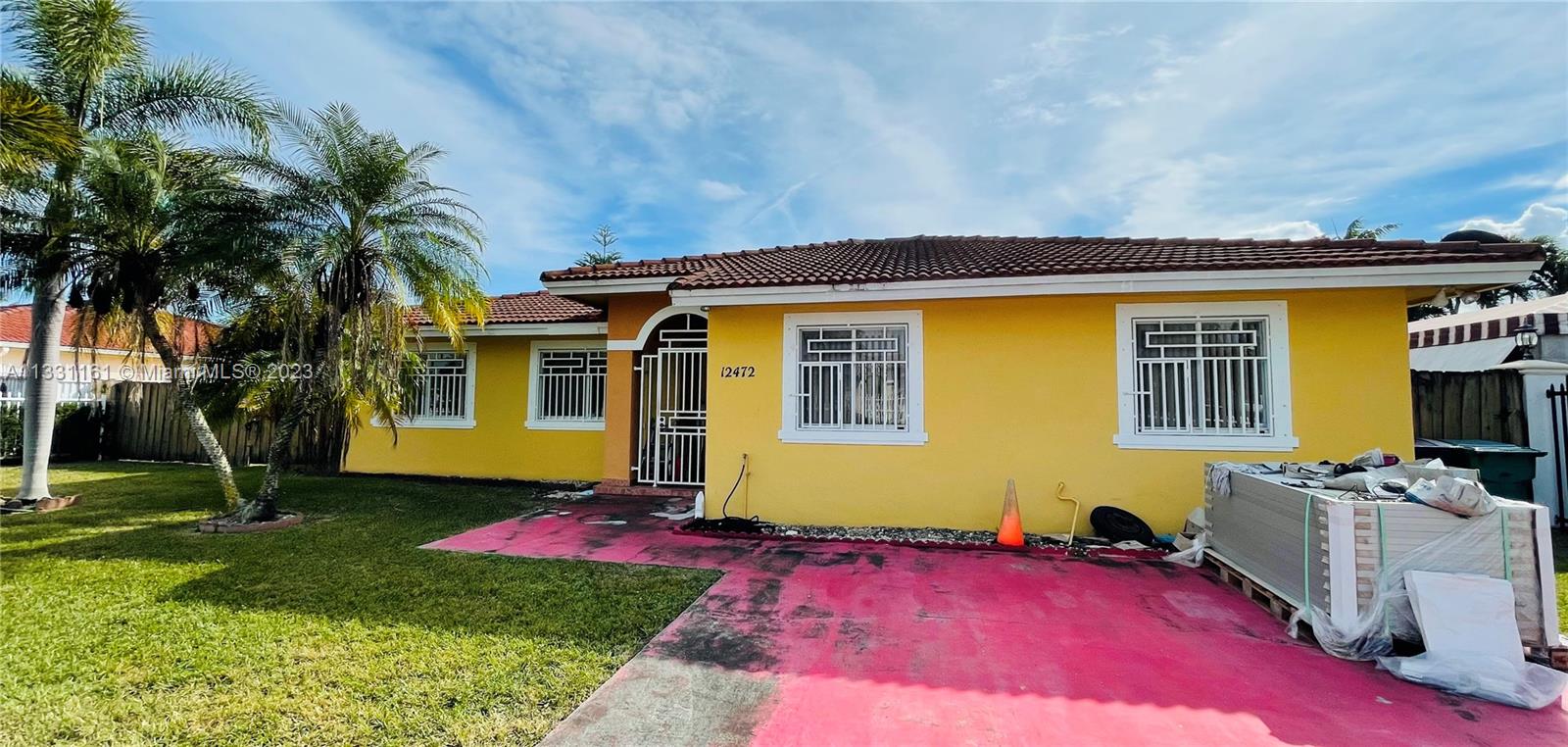 12472 Southwest 220th Street Miami, FL 33170 - Photo 1 of 10 a view of a house with a patio