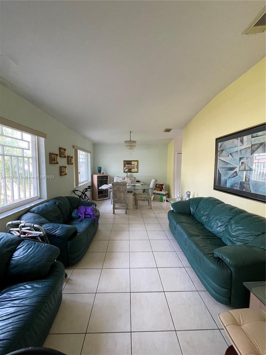 12472 Southwest 220th Street Miami, FL 33170 - Photo 4 of 10 a living room with furniture and a window