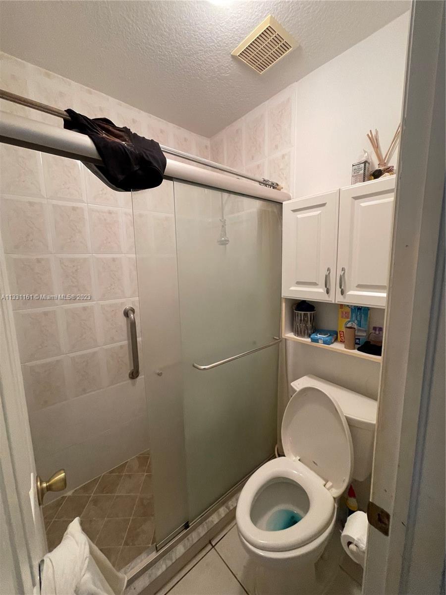 12472 Southwest 220th Street Miami, FL 33170 - Photo 10 of 10 a bathroom with a toilet and a shower