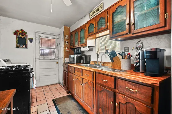 a kitchen with stainless steel appliances granite countertop a refrigerator and a stove