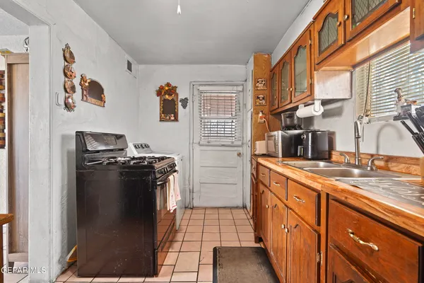 a kitchen with stainless steel appliances granite countertop a refrigerator and a stove