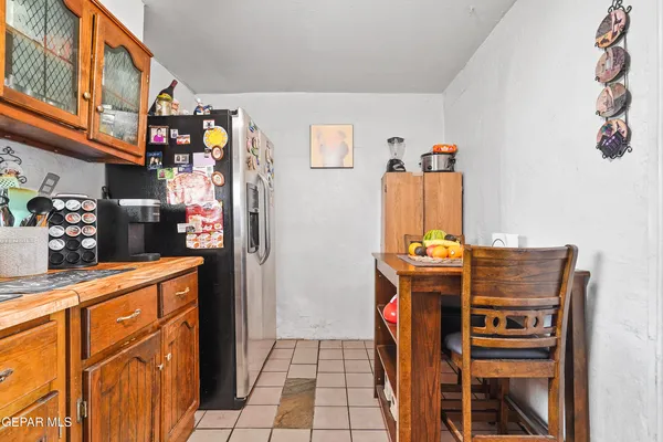 a kitchen with stainless steel appliances granite countertop a refrigerator and a stove